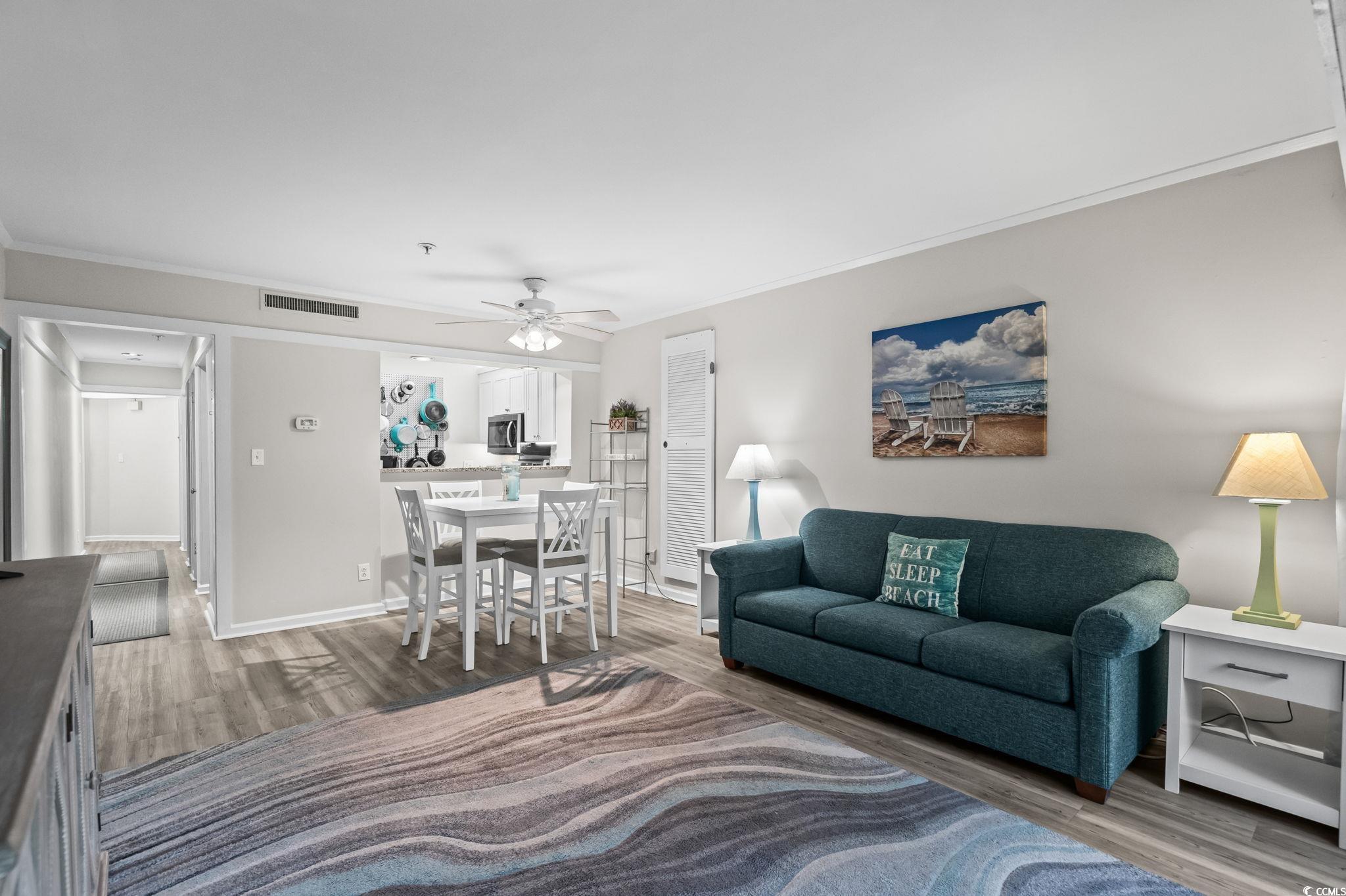 415 Ocean Creek Drive, Unit 2346 Myrtle Beach, SC 29572 - Photo 7 of 40 Living area with light wood-style flooring, ornamental molding, and a ceiling fan