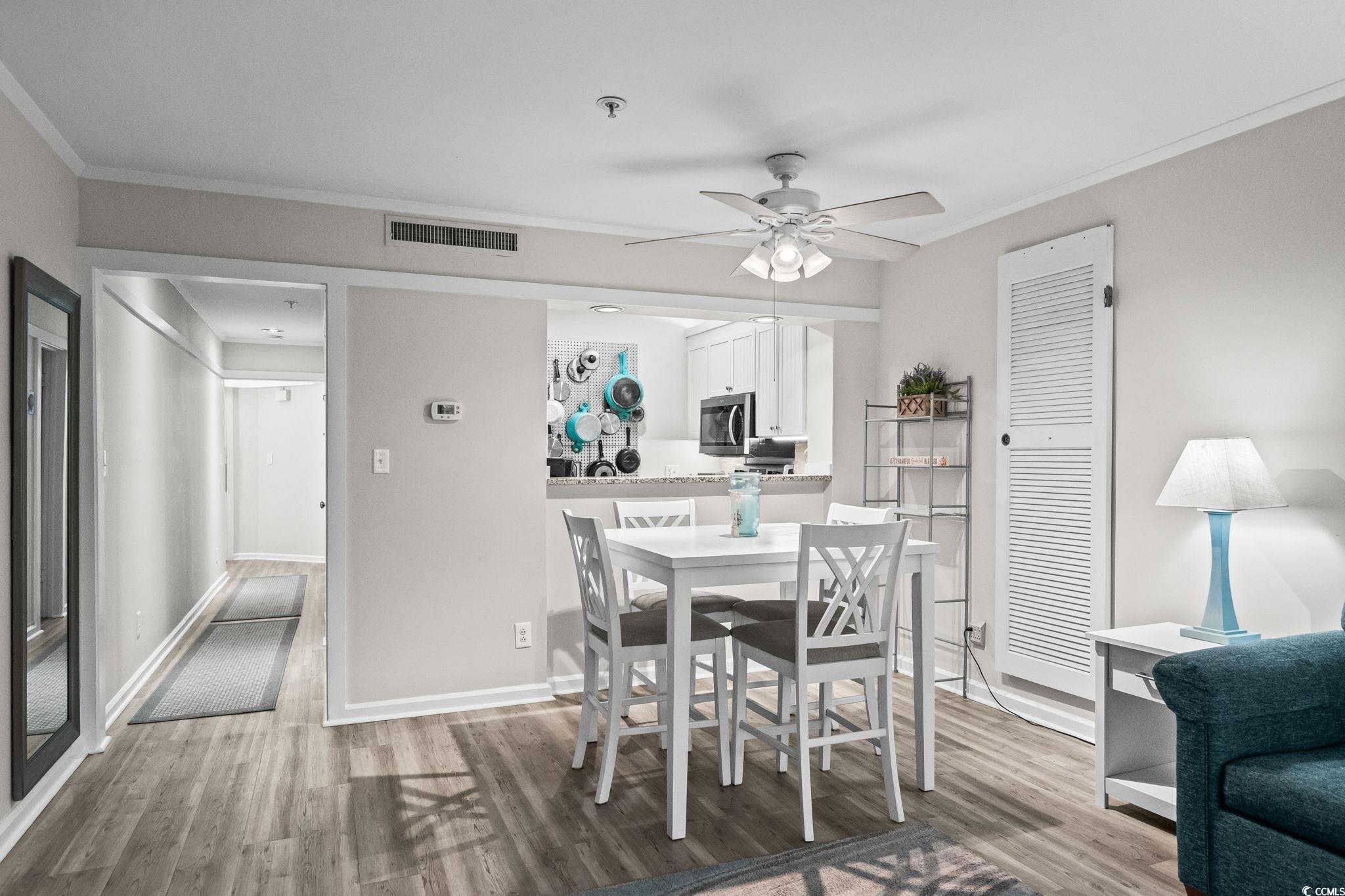 415 Ocean Creek Drive, Unit 2346 Myrtle Beach, SC 29572 - Photo 8 of 40 Dining space featuring ornamental molding, light wood-style floors, and ceiling fan