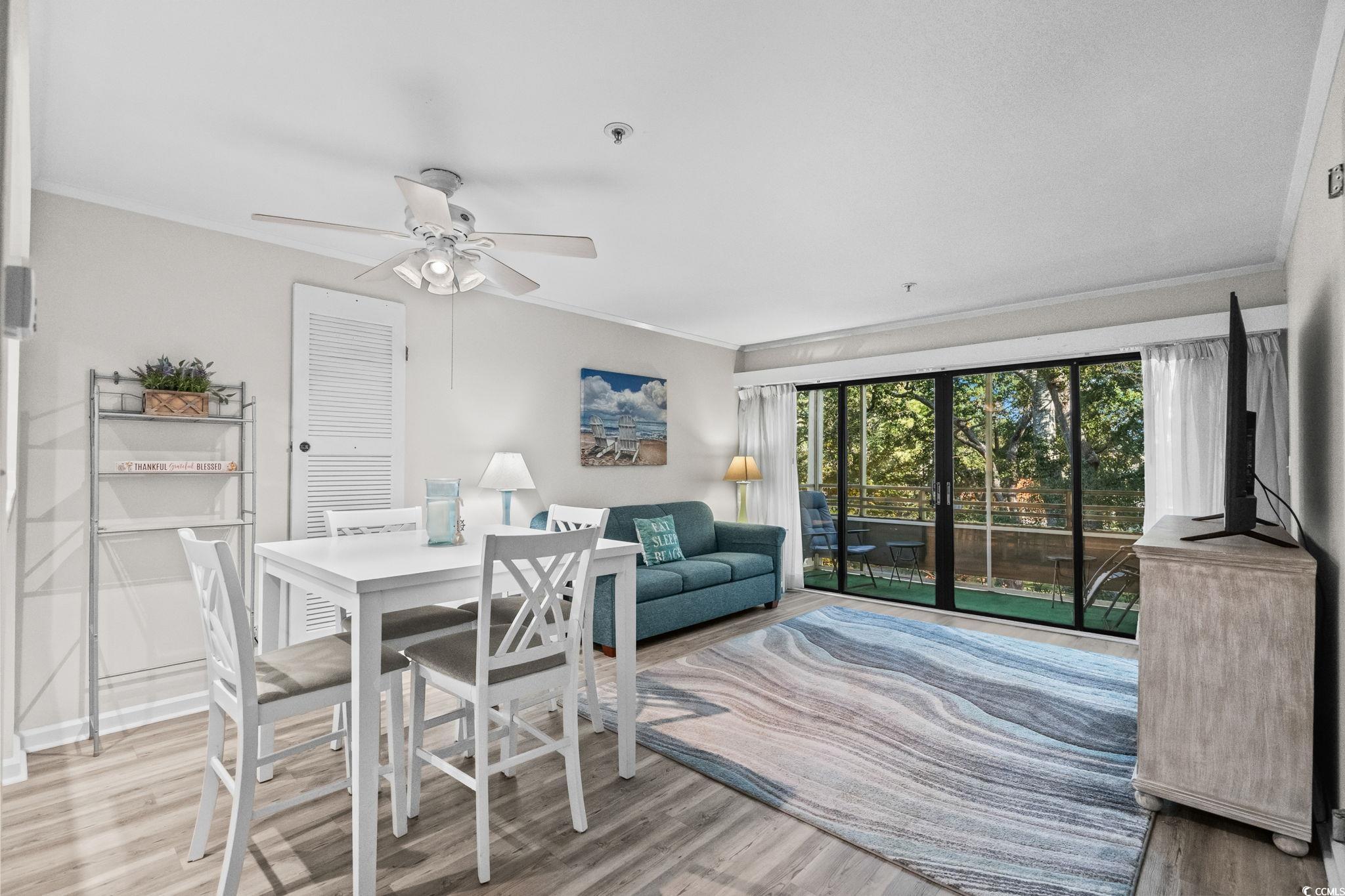 415 Ocean Creek Drive, Unit 2346 Myrtle Beach, SC 29572 - Photo 9 of 40 Dining area with crown molding, light wood-style floors, and a ceiling fan