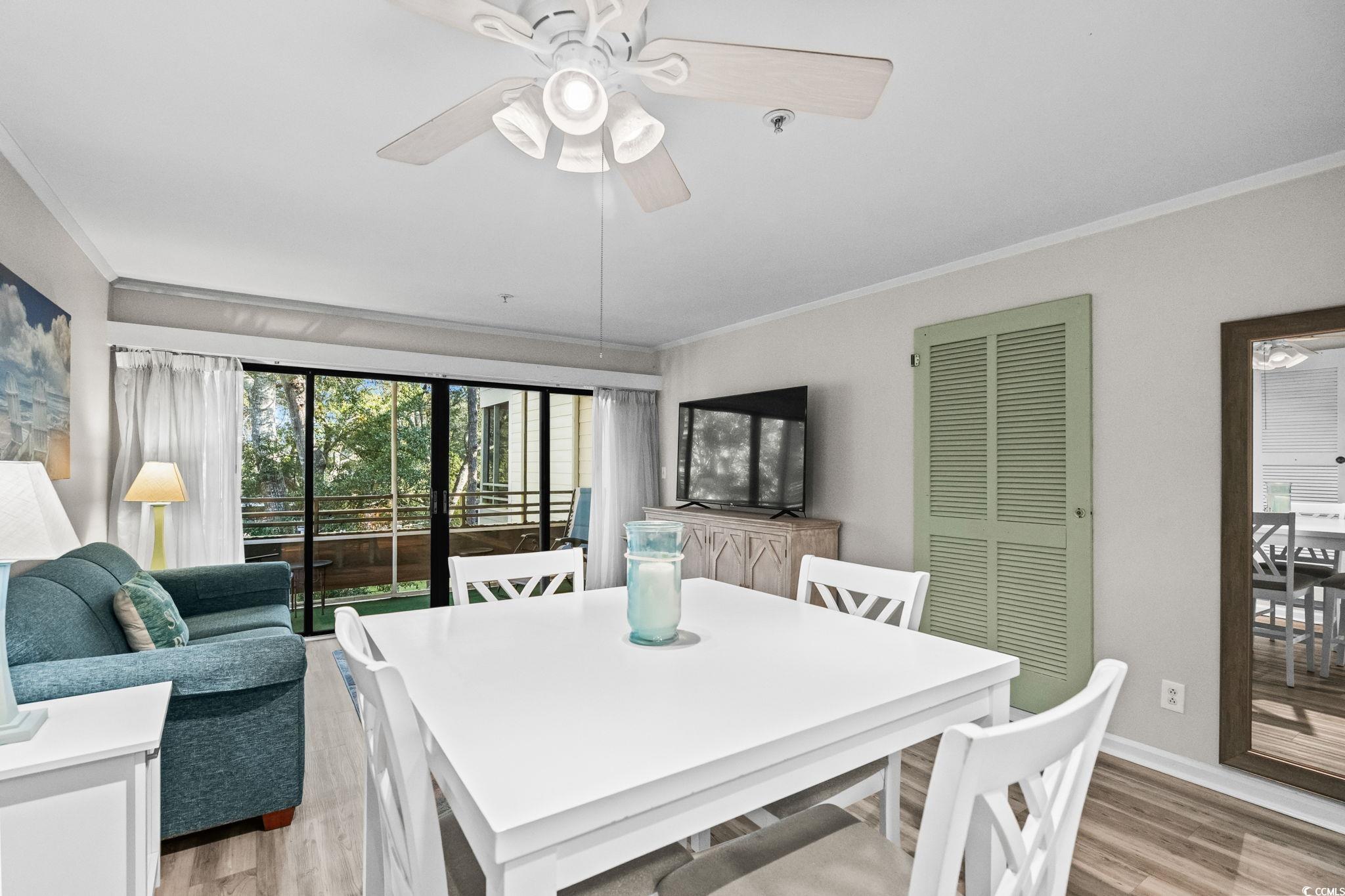 415 Ocean Creek Drive, Unit 2346 Myrtle Beach, SC 29572 - Photo 10 of 40 Dining area with ornamental molding, light wood finished floors, and ceiling fan