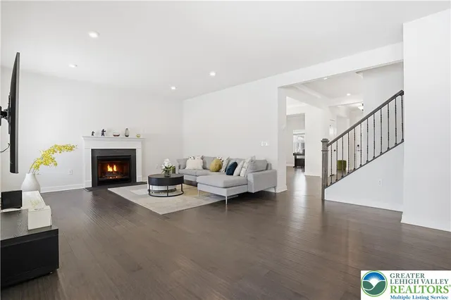 a dining room with furniture wooden floor a potted plant and a chandelier