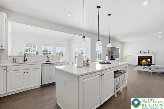a view of a kitchen with workspace and wooden floor