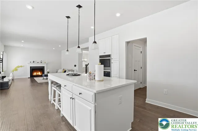 a view of a hallway with wooden floor and windows
