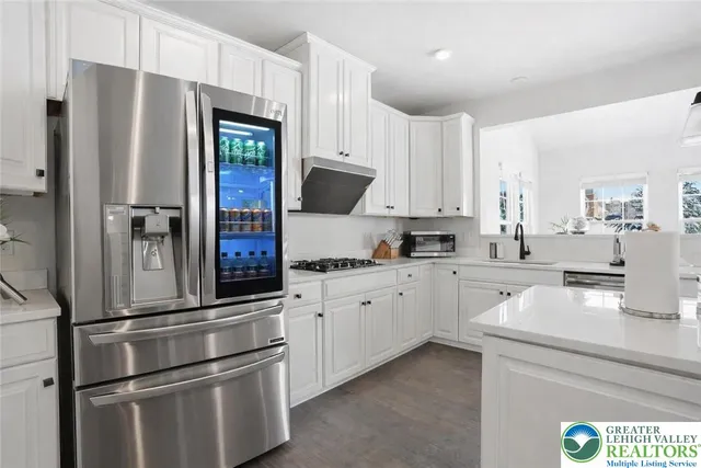 a spacious bedroom with a bed and a flat screen television