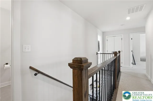 a large white building with a large parking space