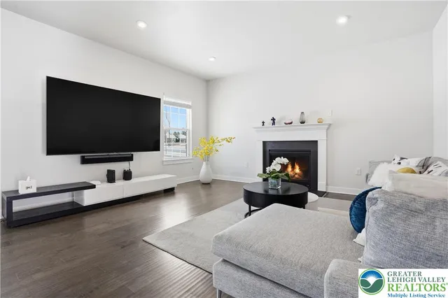 a kitchen with stainless steel appliances a stove a sink a refrigerator and wooden floor