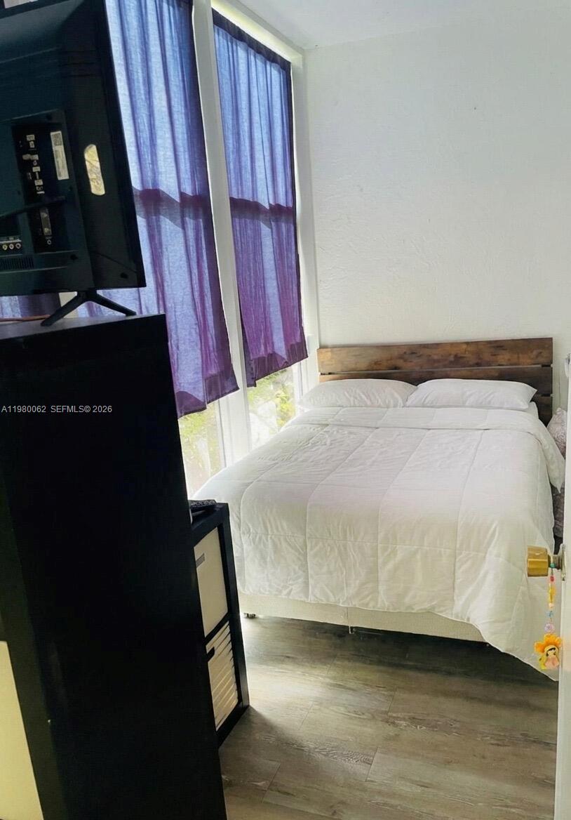 100 Ashbury Road, Unit 305 Hollywood, FL 33024 - Photo 6 of 8 a bed sitting in a bedroom next to a window