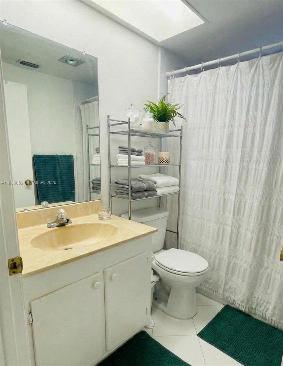 100 Ashbury Road, Unit 305 Hollywood, FL 33024 - Photo 8 of 8 a bathroom with a sink toilet and shower