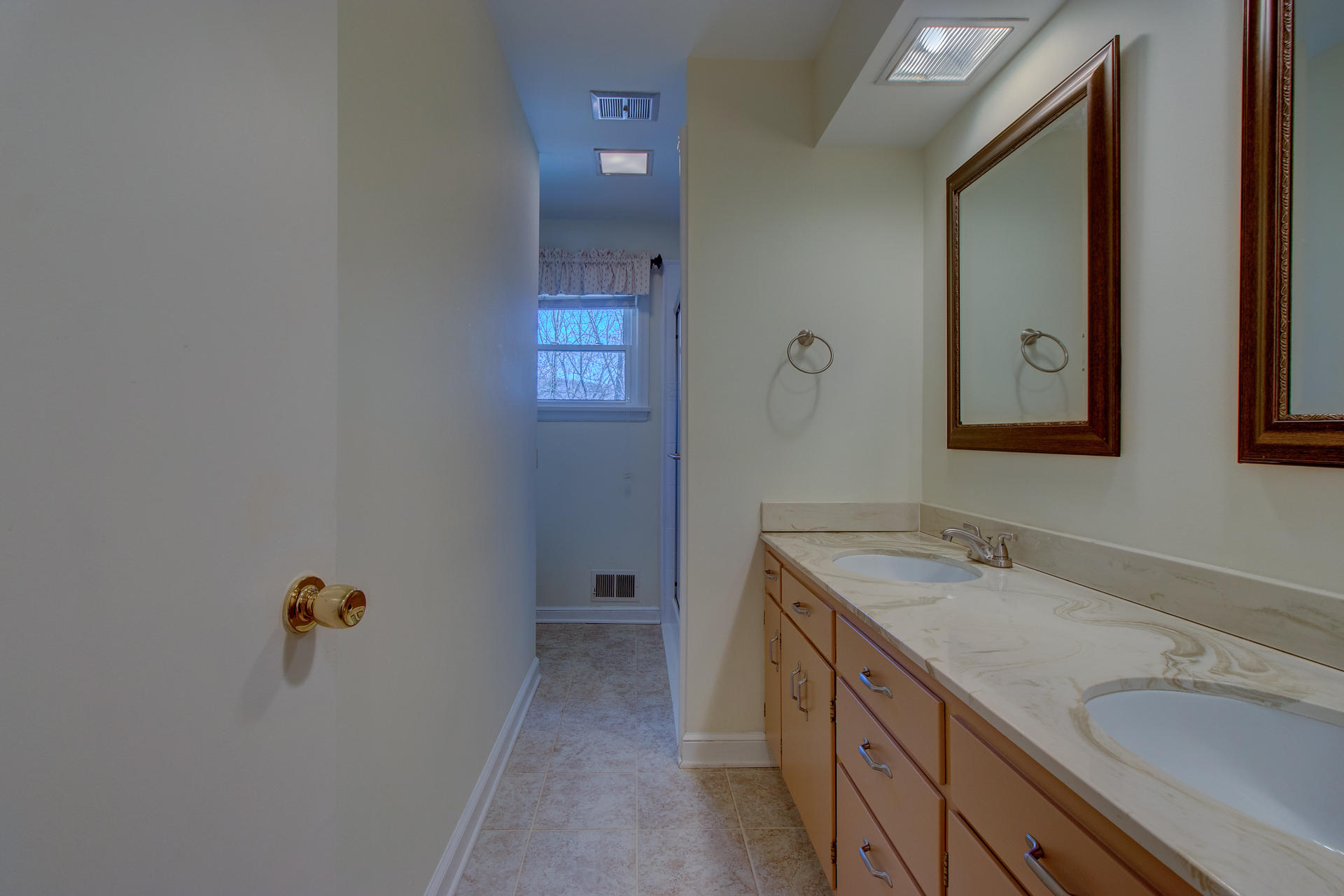 5123 Falcon Ridge Road Roanoke, VA 24018 - Photo 15 of 32 a bathroom with a sink and mirror with window