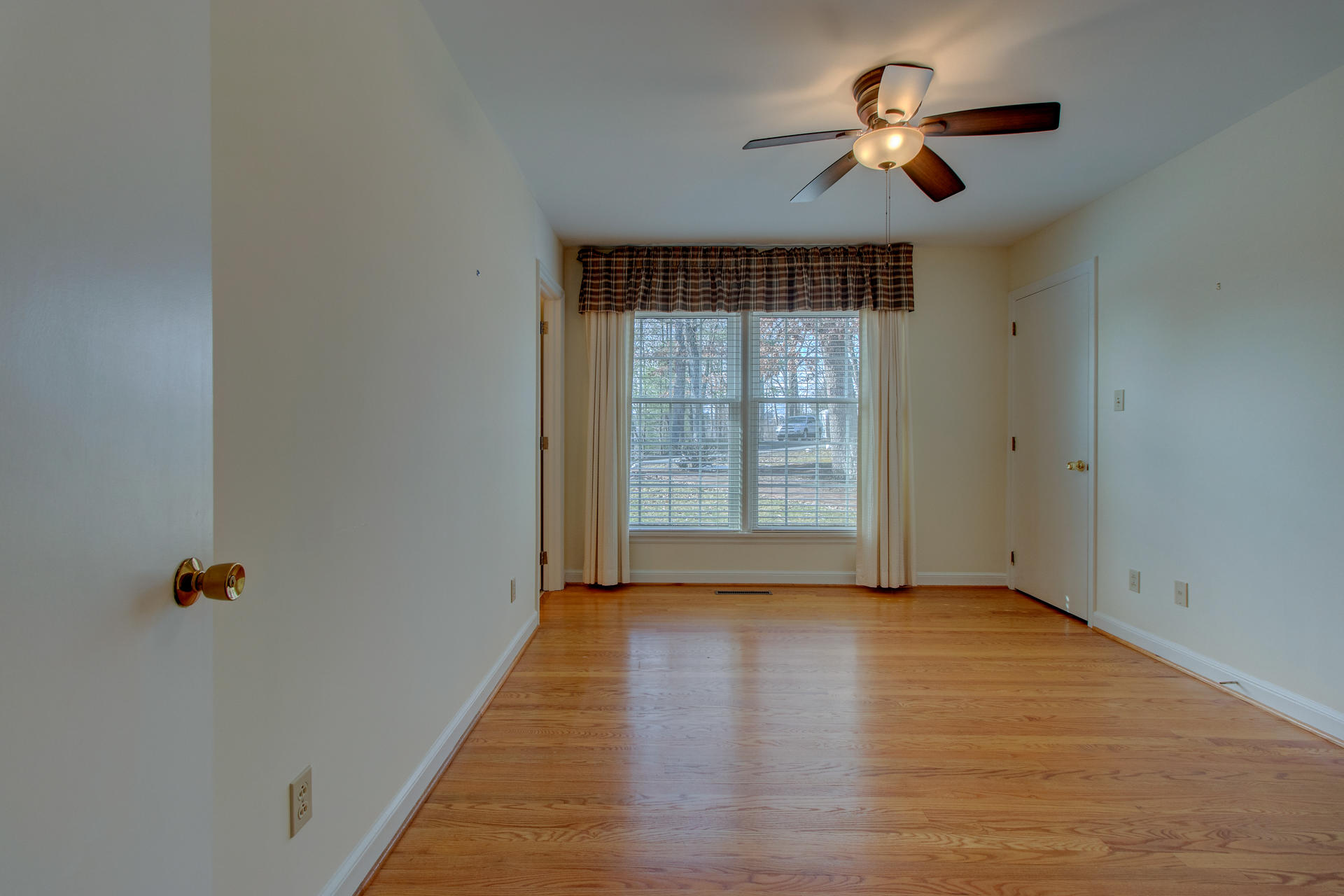 5123 Falcon Ridge Road Roanoke, VA 24018 - Photo 16 of 32 wooden floor in an empty room with a window