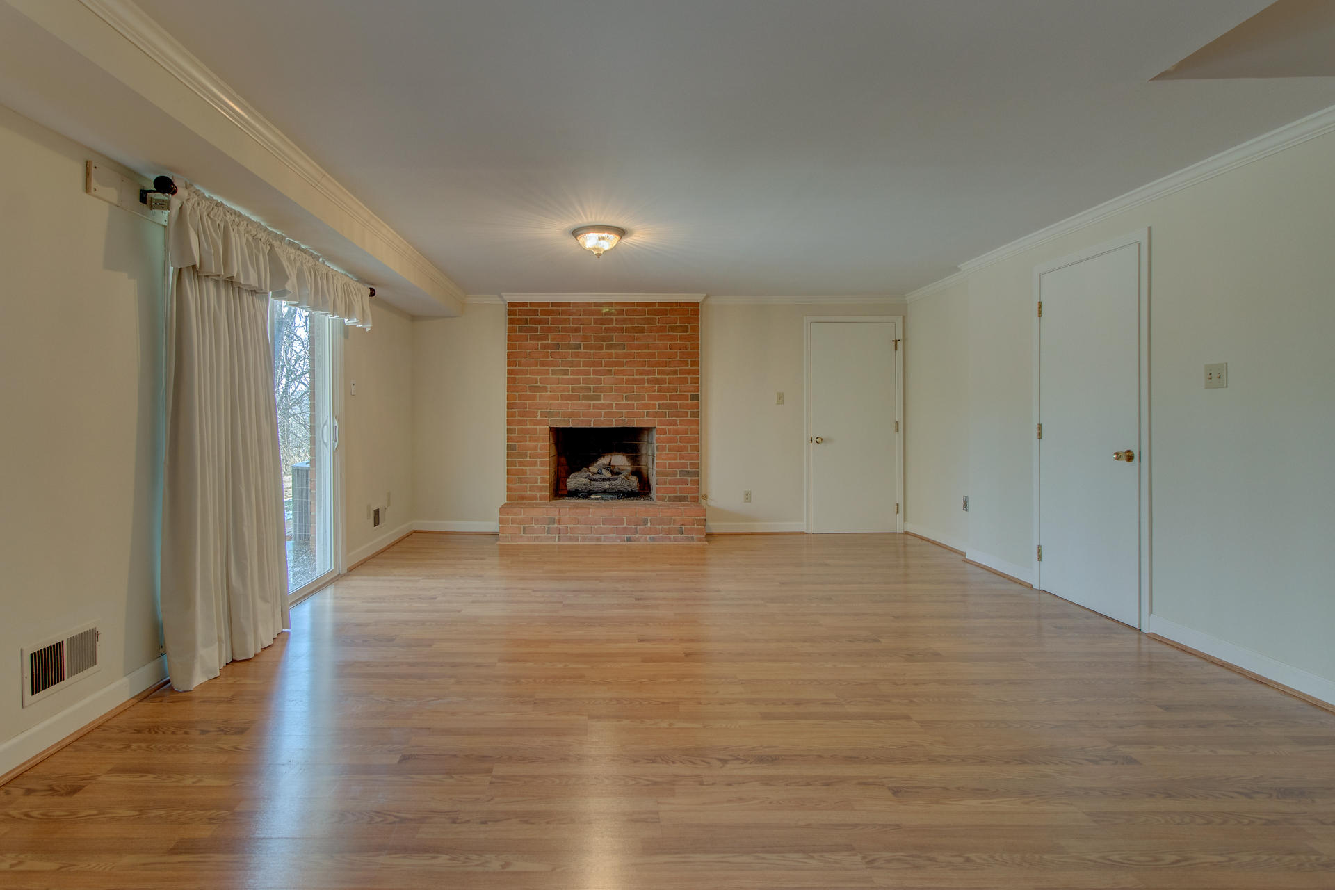 5123 Falcon Ridge Road Roanoke, VA 24018 - Photo 26 of 32 a view of empty room with wooden floor and fireplace