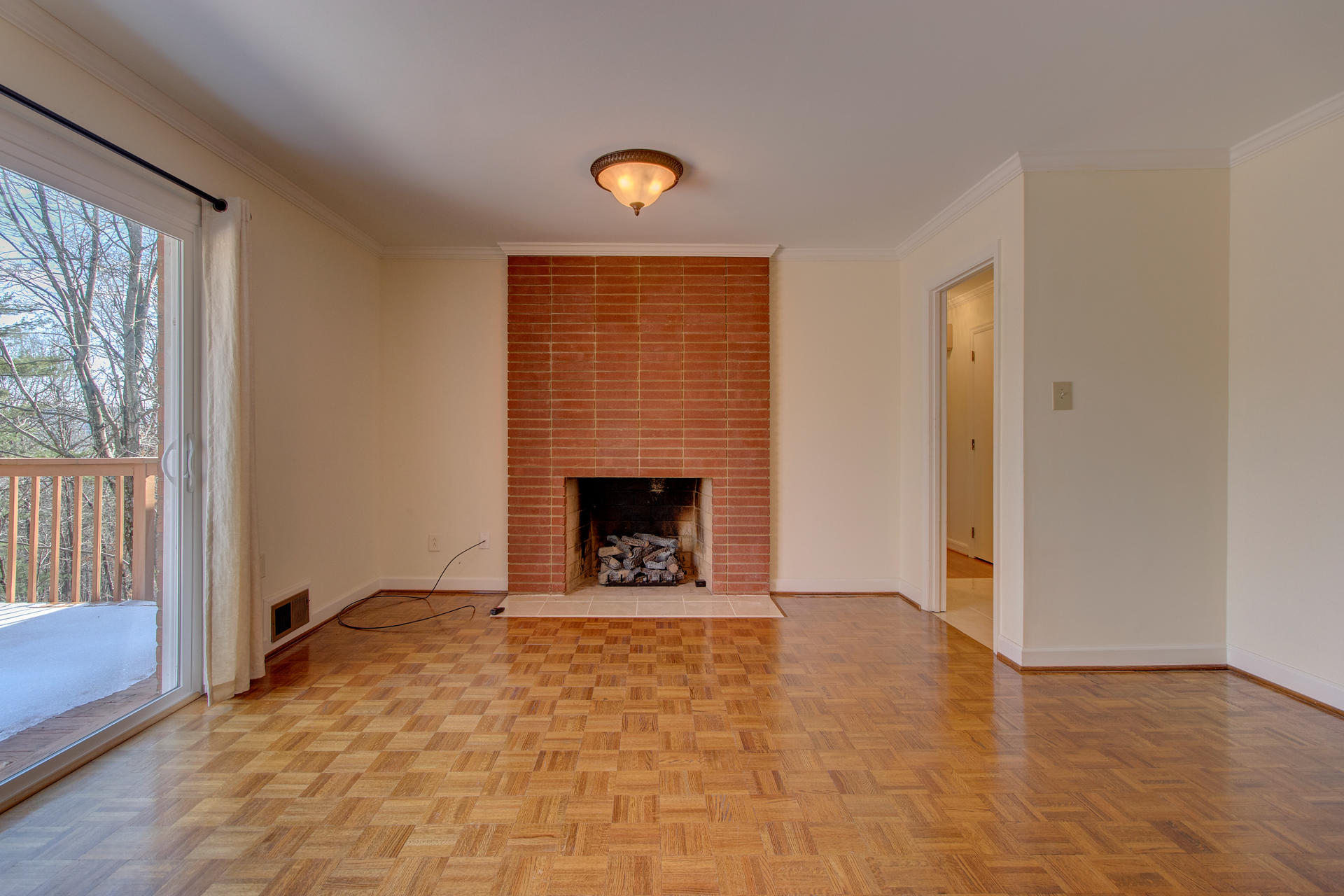 5123 Falcon Ridge Road Roanoke, VA 24018 - Photo 4 of 32 a view of an empty room with a window and a fireplace