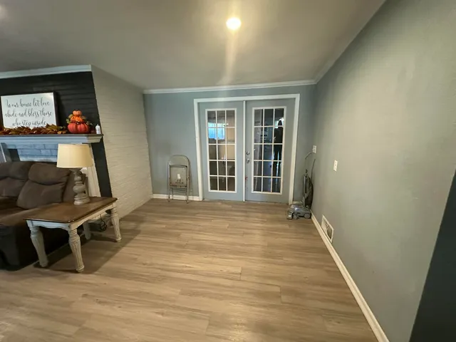 a view of a room with wooden floor and chair