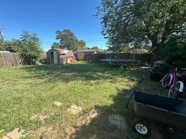 a view of a wooden deck and a yard