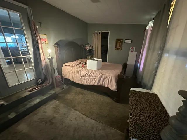 a bed sitting in a bedroom next to a window