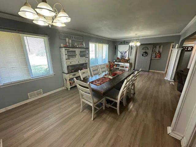 a view of a dining room with furniture and wooden floor