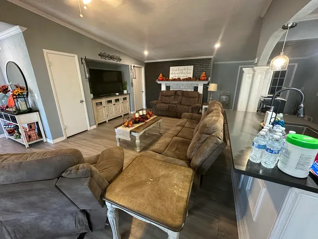a living room with furniture and a flat screen tv