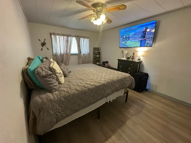 a bedroom with a bed and a chandelier