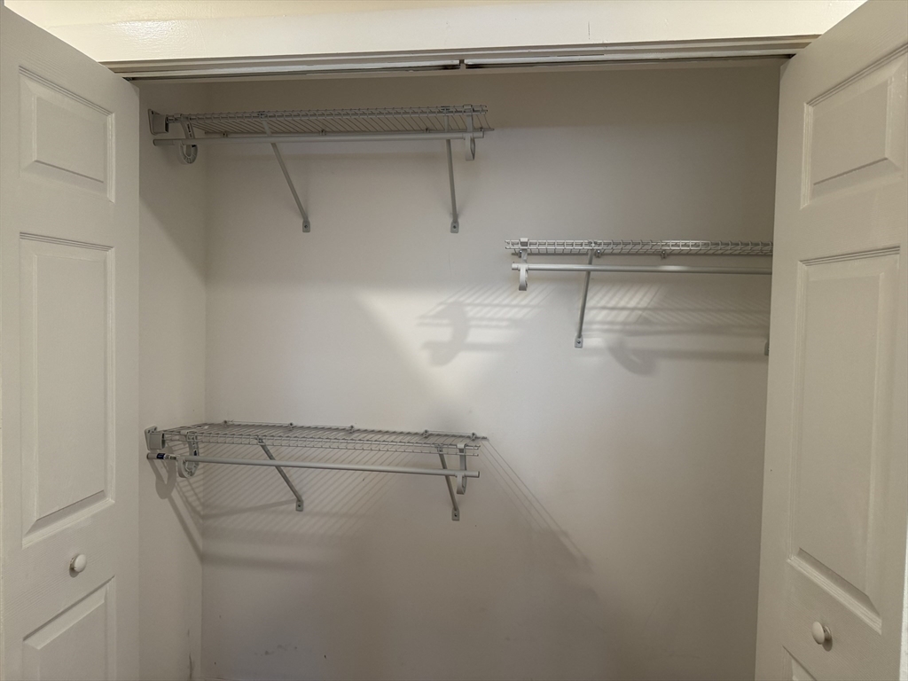 351 Village Street, Unit FIRST Millis, MA 02054 - Photo 7 of 9 a view of a room with racks on the wall