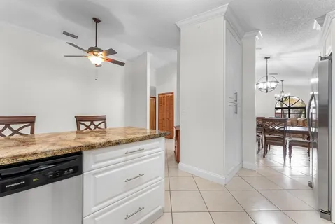 a kitchen with granite countertop a stove top oven microwave and cabinets