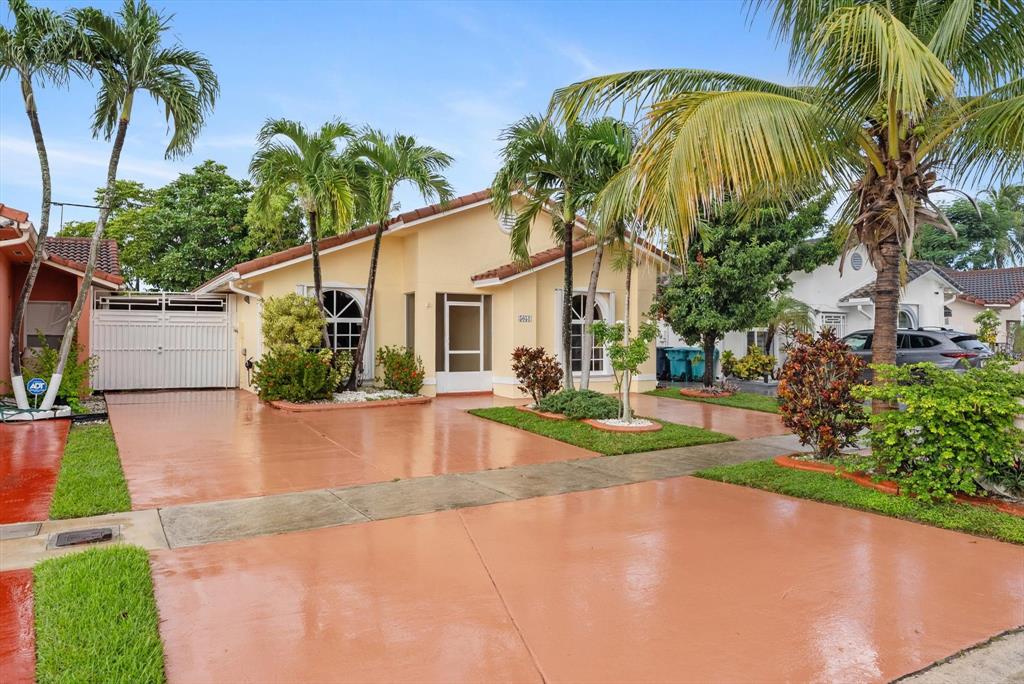 5051 Southwest 142nd Place Miami, FL 33175 - Photo 2 of 30 a view of a white house with palm trees