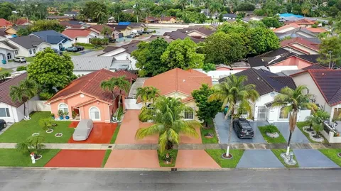 an aerial view of houses with outdoor space