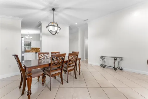 a view of a dining room with furniture and chandelier