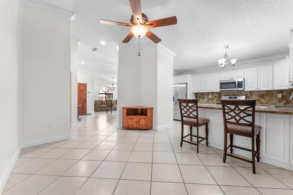 5051 Southwest 142nd Place Miami, FL 33175 - Photo 7 of 30 a kitchen with stainless steel appliances a refrigerator and microwave