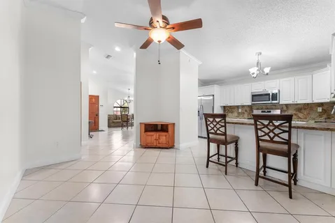 a kitchen with stainless steel appliances granite countertop a stove a sink a microwave and a refrigerator