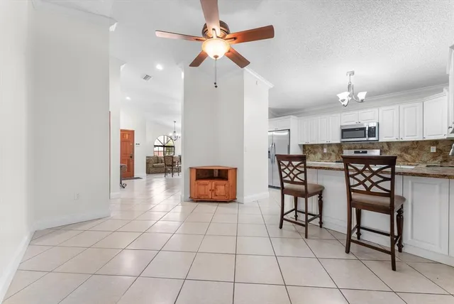 a kitchen with stainless steel appliances granite countertop a stove a sink a microwave and a refrigerator