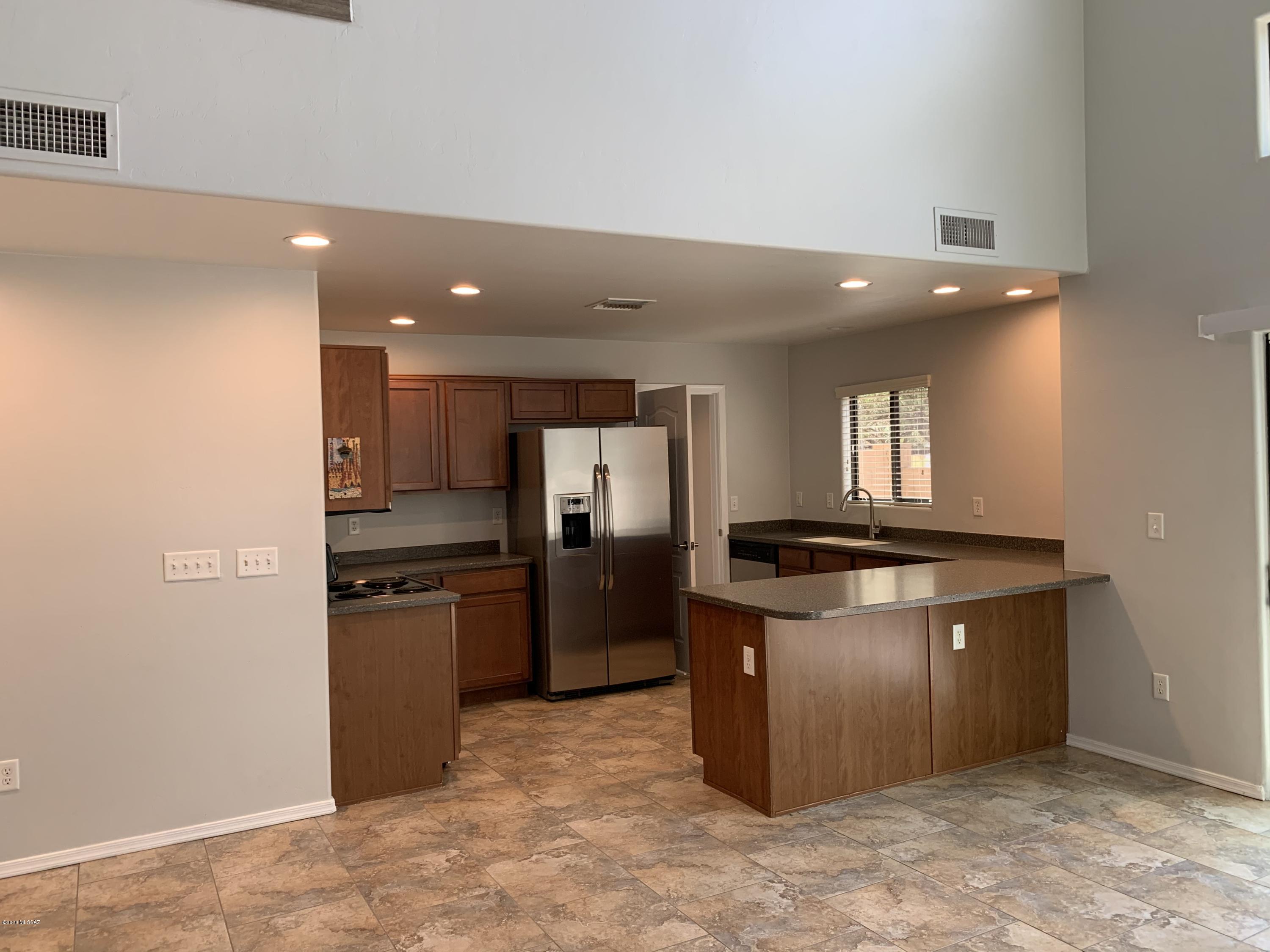 4181 North Fortune Loop Tucson, AZ 85719 - Photo 6 of 39 a kitchen with stainless steel appliances granite countertop a stove and a refrigerator