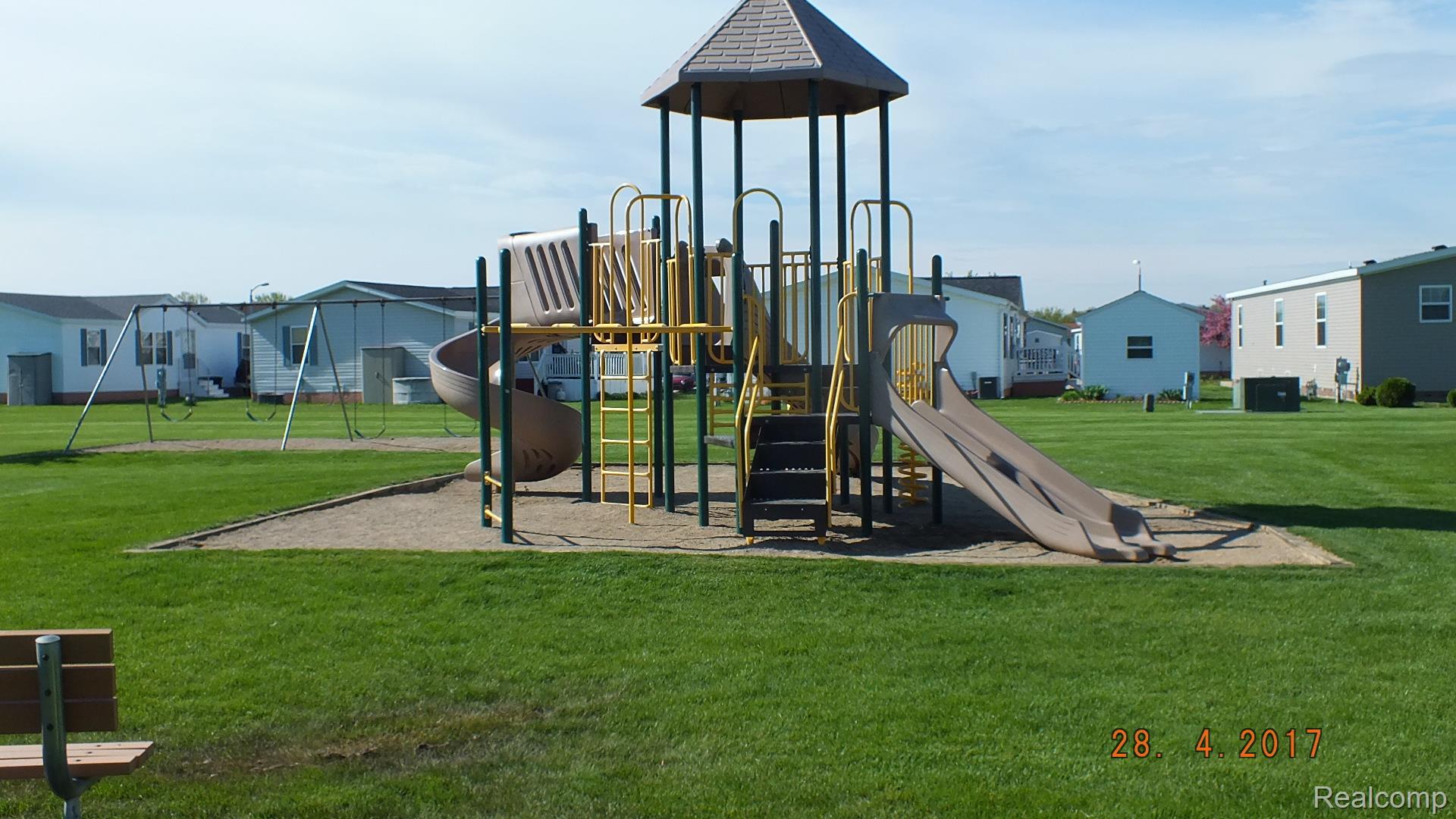 5931 Megans Ridge Monroe, MI 48161 - Photo 11 of 13 Community playground featuring multiple slides and a climbing structure