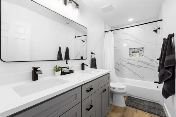 a bathroom with a sink double vanity and toilet