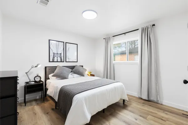 a bedroom with a bed and a window