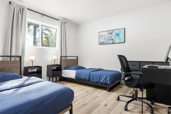 a bedroom with a bed and a desk