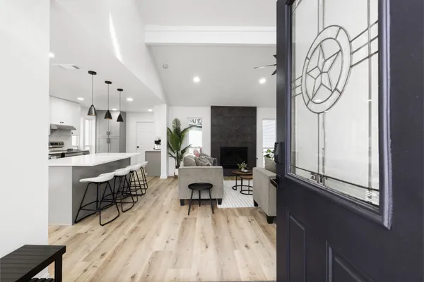 a living room with furniture a table and large window