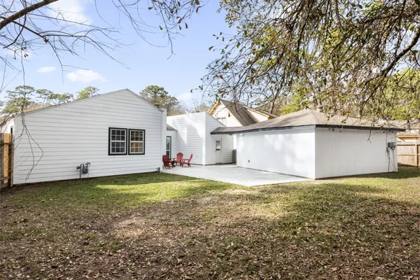 a view of a backyard with a house and a large tree