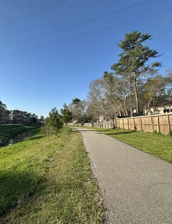 a view of swimming pool with outdoor seating and trees