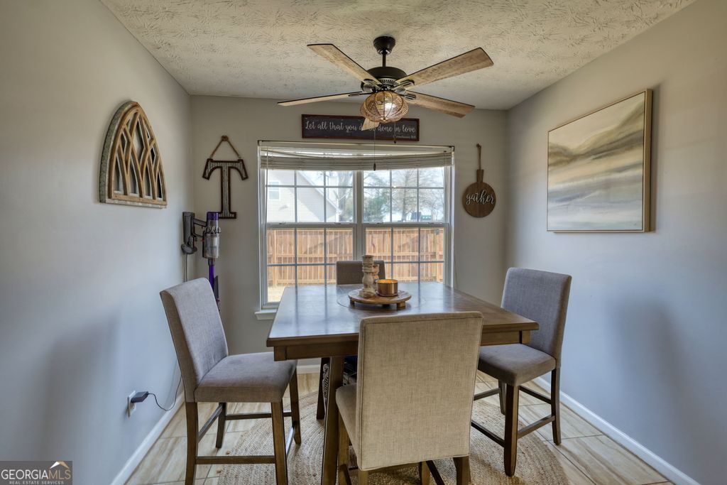 4610 Atlanta Highway Rutledge, GA 30663 - Photo 12 of 32 a dining room with furniture a chandelier and wooden floor
