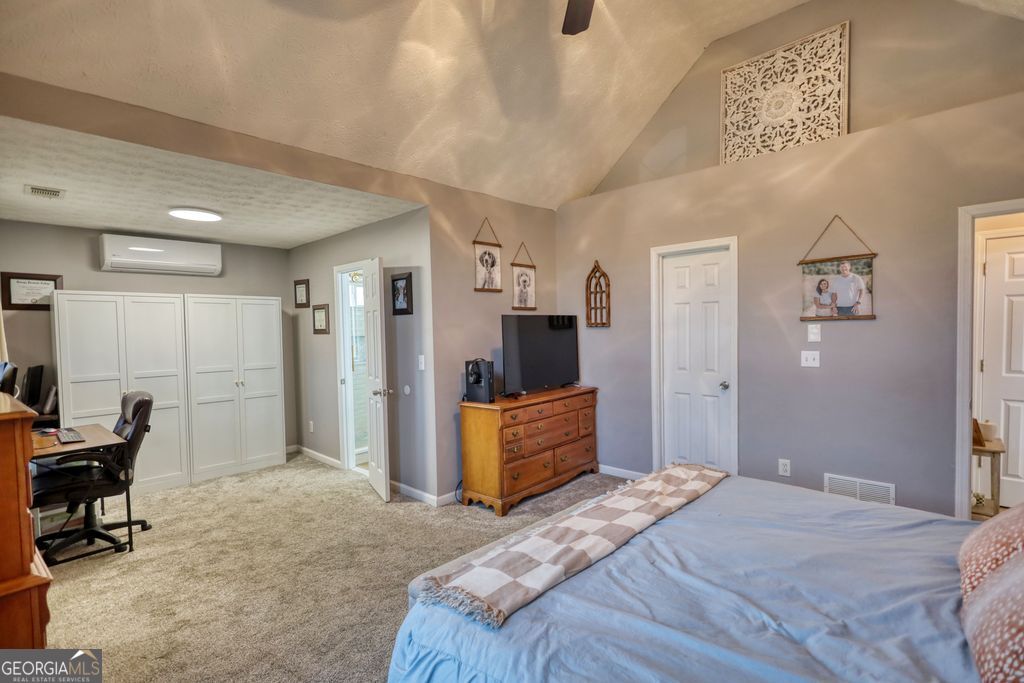 4610 Atlanta Highway Rutledge, GA 30663 - Photo 17 of 32 a bedroom with a bed and furniture