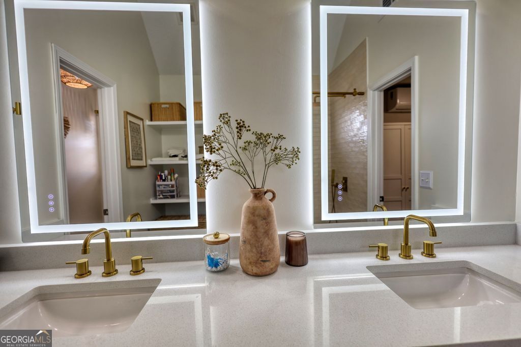 4610 Atlanta Highway Rutledge, GA 30663 - Photo 19 of 32 a bathroom with a granite countertop sink and a mirror