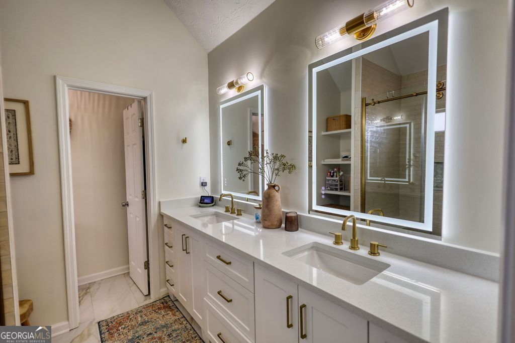 4610 Atlanta Highway Rutledge, GA 30663 - Photo 20 of 32 a bathroom with double vanity and a mirror
