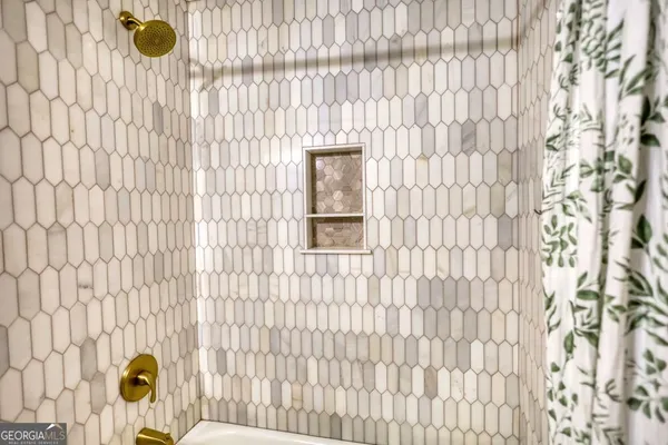 a bathroom with a window and shower curtain
