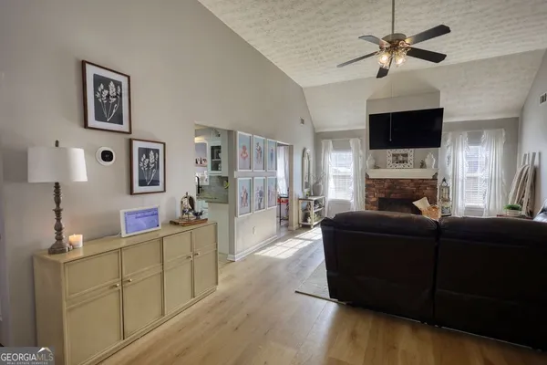 a living room with furniture a flat screen tv and a fireplace