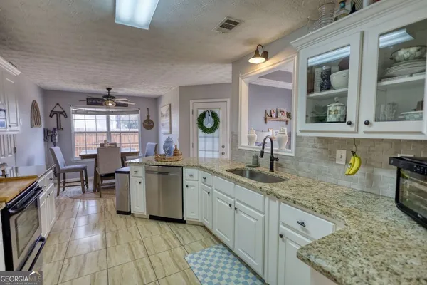 a kitchen with a sink and cabinets