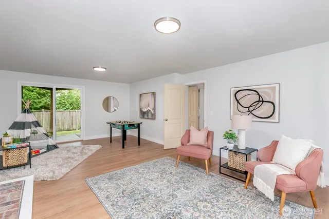 a view of a house with backyard and sitting area
