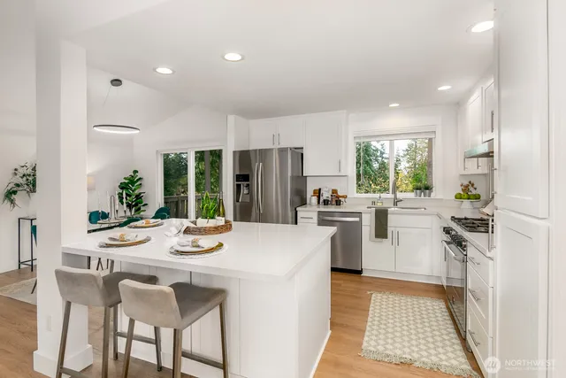 a kitchen with a stove a sink and a microwave