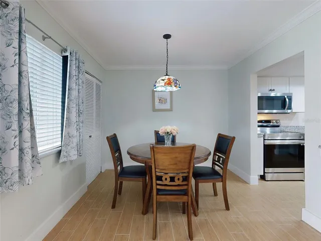 a dining room with a wooden table and chairs