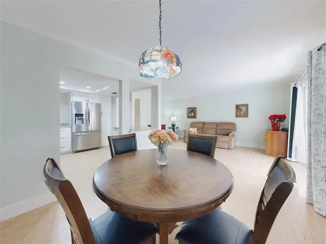 a living room with furniture a table and chairs