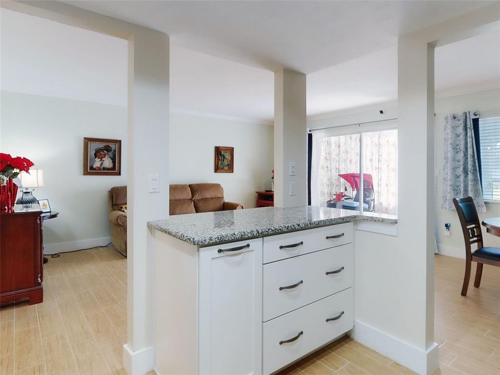 588 Bahia Circle, Unit A Ocala, FL 34472 - Photo 20 of 49 a living room with granite countertop furniture and a flat screen tv